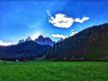 Panoramic view of landscape and mountains against blue sky