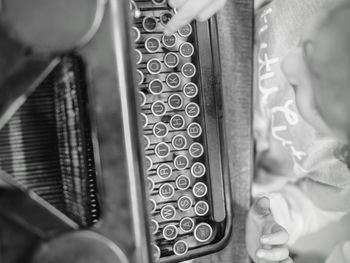 Directly above shot of child typing on vintage typewriter at table