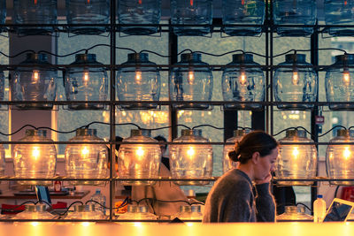 Man sitting in illuminated restaurant