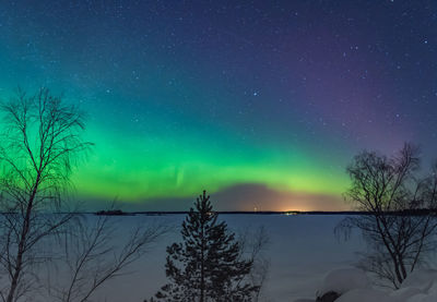 Scenic view of lake against sky at night