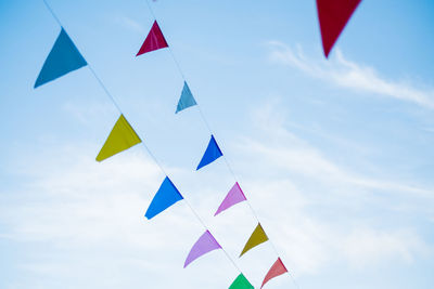 Low angle view of flags against sky