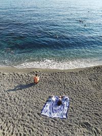 High angle view of people relaxing on beach