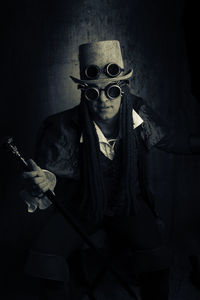 Portrait of man wearing eyewear in darkroom