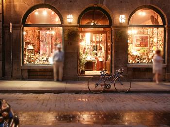 Men on bicycle in city at night