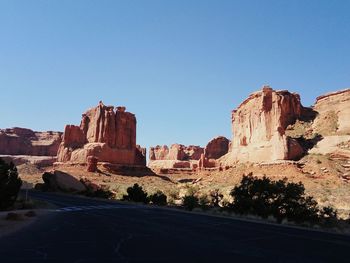 View of rock formation against clear blue sky