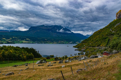 Scenic view of lake and mountains against sky