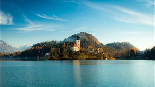 Scenic view of lake and mountains against sky