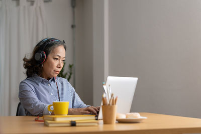 Young woman using laptop at home