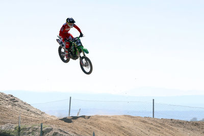 Low angle view of man riding bicycle against sky