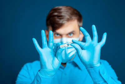 Portrait of man against blue background