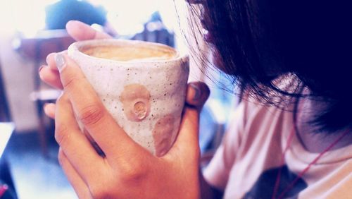 Close-up of woman holding coffee cup