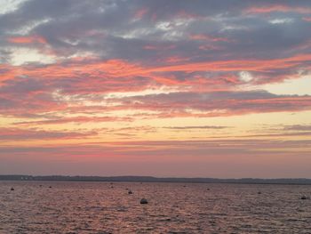 Scenic view of sea against romantic sky at sunset