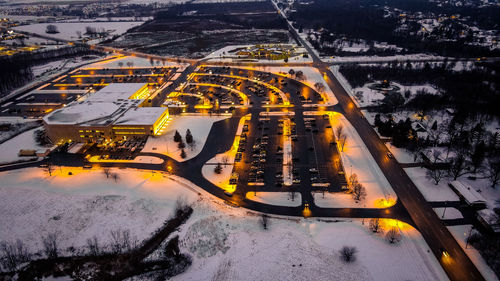 Brightly lit parking lot and building at night. taken in green bay wisconsin. fresh snow. 