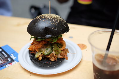 Burger served in plate on table at restaurant