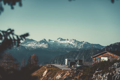 Panoramic view of buildings and mountains against clear sky