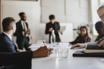 Hand of businesswoman taking down notes during business meeting at office