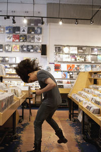 Young man dancing in a record store