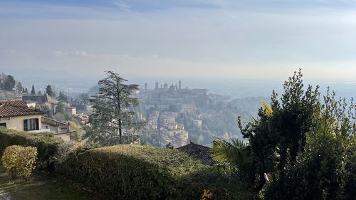 Panoramic view of buildings in city against sky
