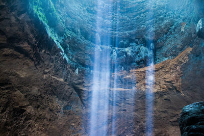 Light beam in cave by rock formation