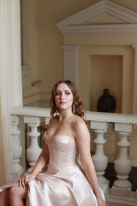 Beautiful young woman sitting indoors