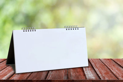 Close-up of blank calendar on wooden table