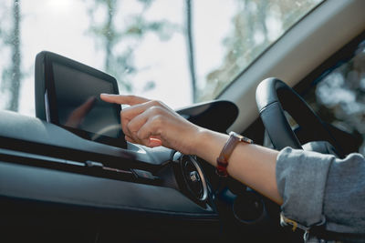 Close-up of woman using smart phone in car