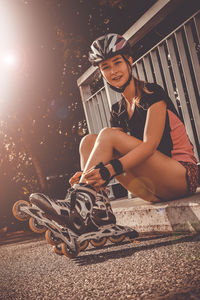 Portrait of smiling young woman wearing roller skates