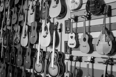 Close-up of guitars hanging in store for sale