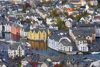 High angle view of buildings by river in town