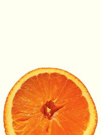 Close-up of orange slice against white background