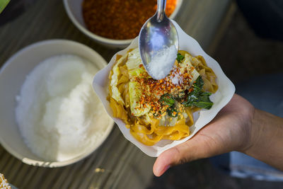 High angle view of person holding ice cream in plate