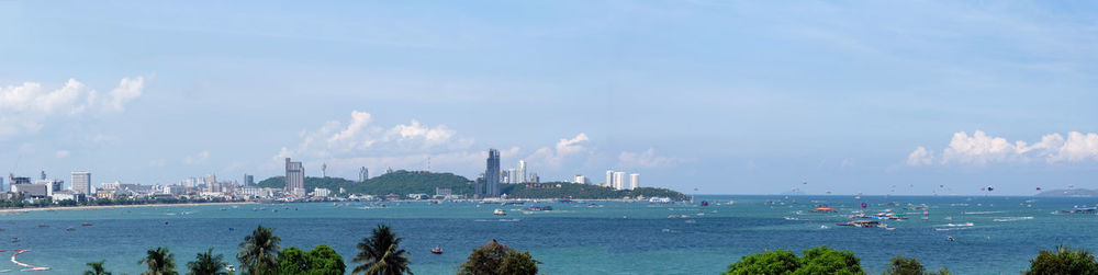 Panoramic view of sea and buildings against sky