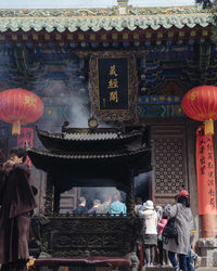 People in temple outside building