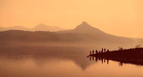 Scenic view of lake against sky during sunset