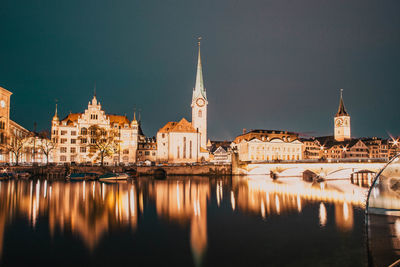 Reflection of illuminated buildings in city