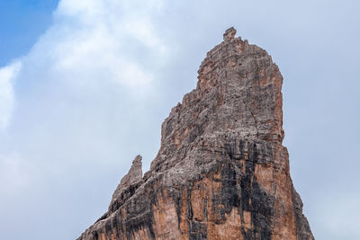 Low angle view of rock formation on mountain against sky