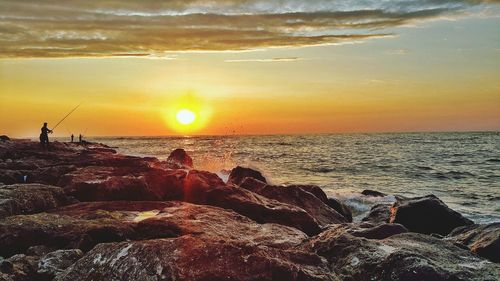 Scenic view of sea against sky during sunset