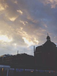 Low angle view of building against cloudy sky