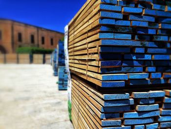 Close-up of stack of building against blue sky