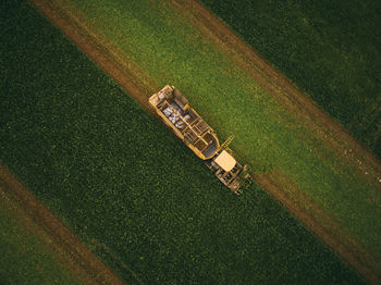 High angle view of tire tracks on field