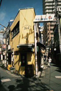 Cars on street by buildings in city