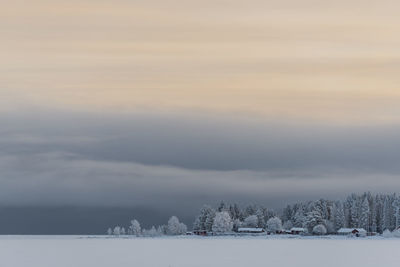 Scenic view of snow field against sky during sunset
