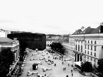 People on road in city against sky