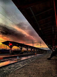 Illuminated bridge against sky at sunset