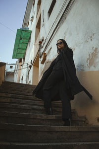 Low angle view of woman standing on staircase