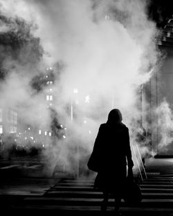 Rear view of woman walking on street in city