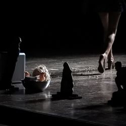 Low section of woman walking in darkroom