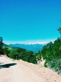 Scenic view of mountains against blue sky