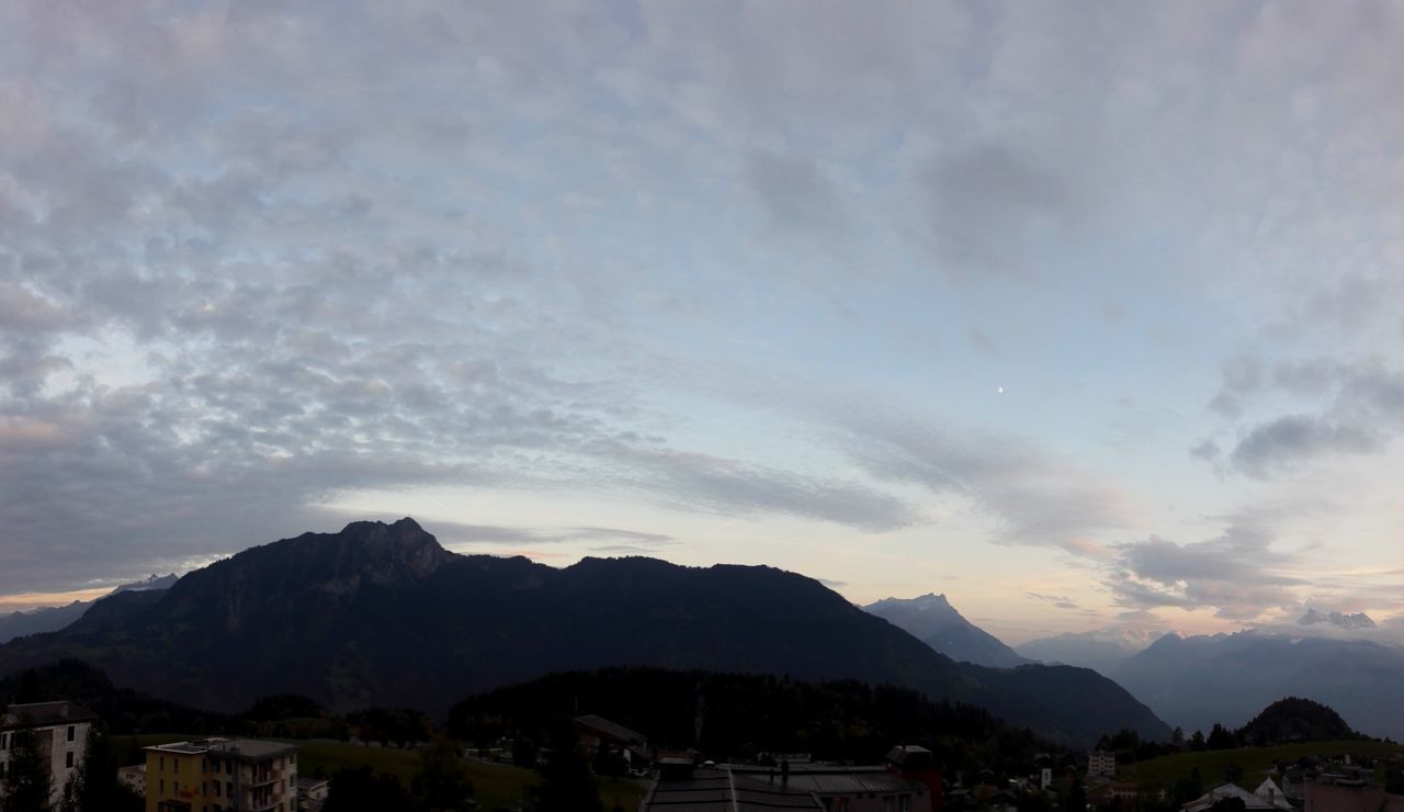 HOUSES AGAINST MOUNTAINS