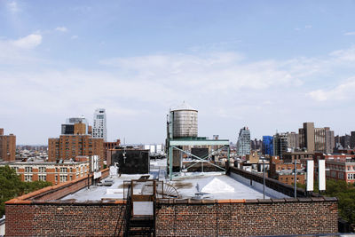 View of cityscape against cloudy sky